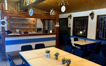 A restaurant dining area with a blue and white nautical and fishing hut theme 