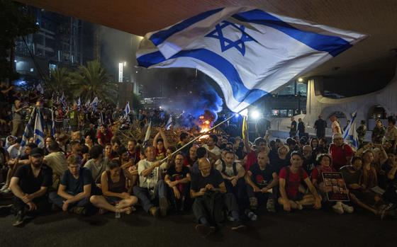 People block a road as they protest, calling for a deal for the immediate release of hostages held in the Gaza Strip by Hamas, in Tel Aviv, Israel, Sunday, Sept. 1, 2024. (AP Photo/Ohad Zwigenberg)