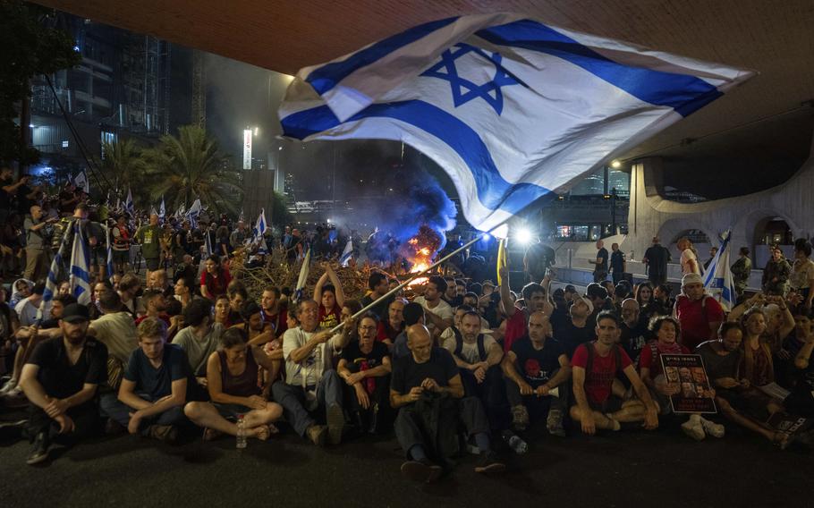 People block a road as they protest, calling for a deal for the immediate release of hostages held in the Gaza Strip by Hamas, in Tel Aviv, Israel, Sunday, Sept. 1, 2024.