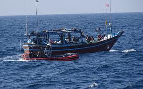 A crew from the U.S. Coast Guard cutter Emlen Tunnell seizes illegal drugs from a stateless vessel in the Arabian Sea on Feb. 7, 2025. 