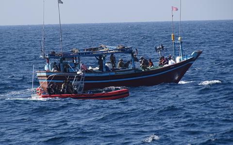 A crew from the U.S. Coast Guard cutter Emlen Tunnell seizes illegal drugs from a stateless vessel in the Arabian Sea on Feb. 7, 2025. 