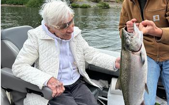 Centenarian Betsy Jeffords is amazed at her catch, skillfully netted for her by 16-year-old Mason Waddle of Longview, Wash.