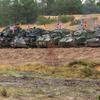 Vehicles with flags representing their countries are lined up in Adazi, Latvia.