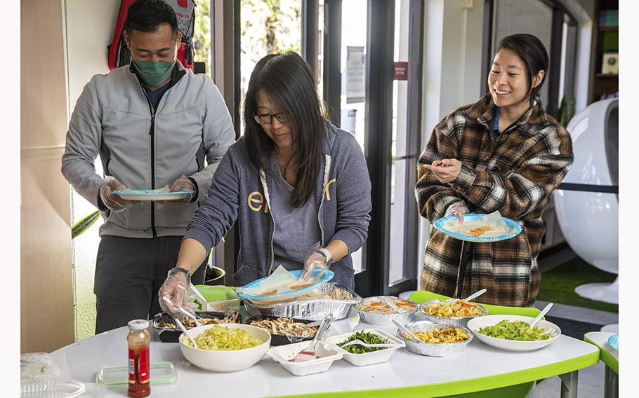 Clement Lee, left, Yvonne Gee and Crystal Huang learn how to make Taiwanese spring rolls during a Mandarin class sponsored by the Taiwanese government. 