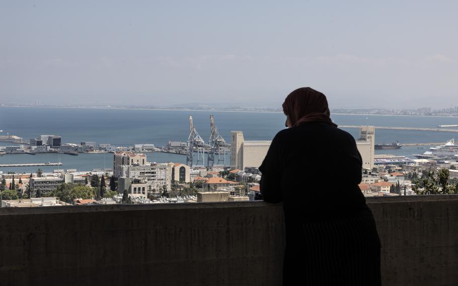 Nadia Hashmar, a Palestinian citizen of Israel, looks out from her apartment in Haifa, Israel, on Sunday. 