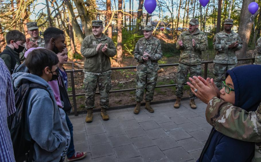 Service members greet children as they walk up the stairs to Ramstein Intermediate School at Ramstein Air Base, Germany, on April 19, 2022. The outsized welcome was part of the school’s celebration for Month of the Military Child. 