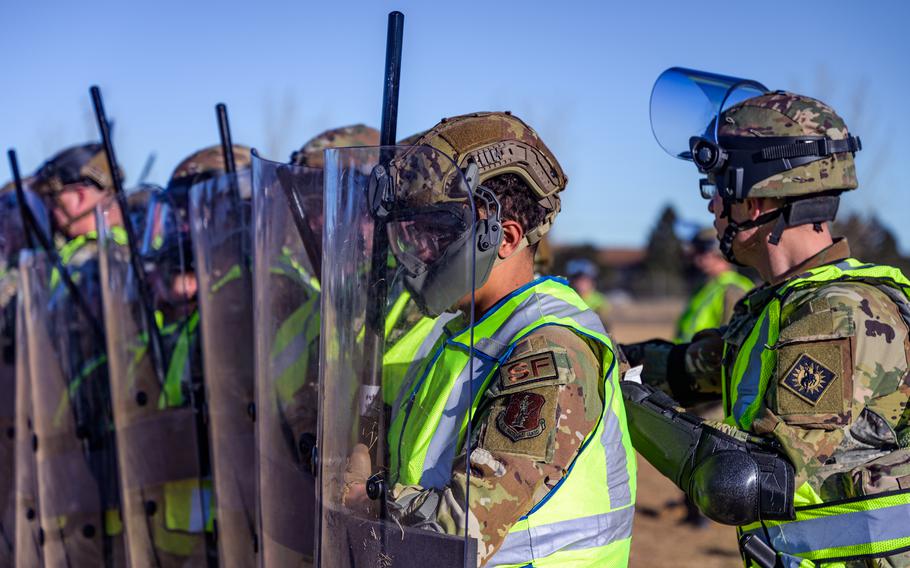 Wyoming National Guardsmen train with riot shields, batons, and protective equipment