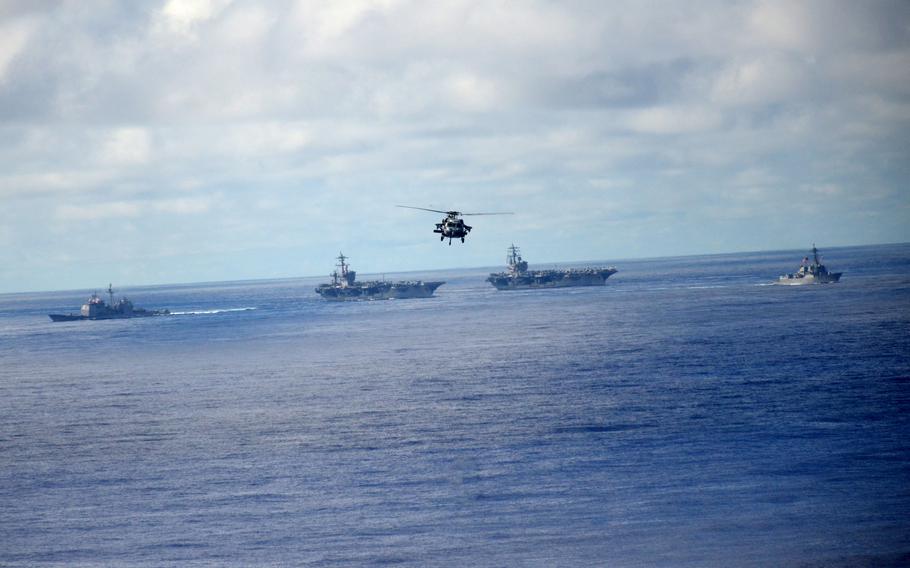 The aircraft carriers USS Ronald Reagan and USS Carl Vinson sail in formation with destroyers and cruisers during training in the Philippine Sea, Monday, Nov. 6, 2023.