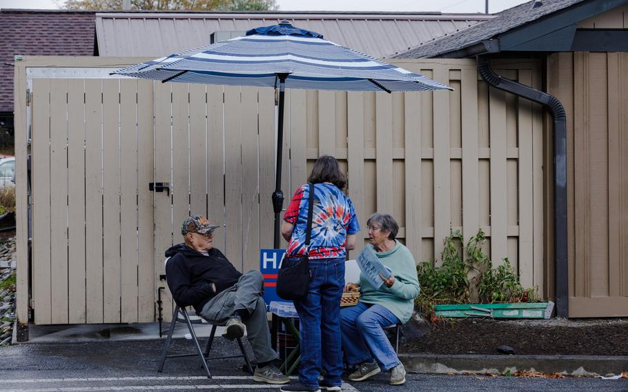 Voters chat after casting early ballots in Burnsville.