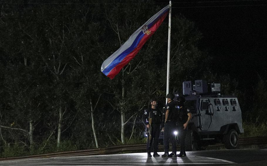 Kosovo police officers guard road in 2023