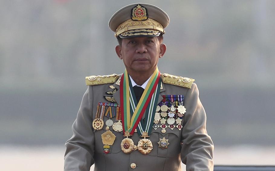 The leading figure of Myanmar’s ruling junta inspects officers during a military parade. He is the sole person in the photo.