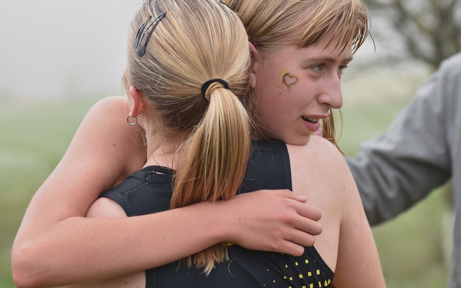 Anna Konon and Regan Stewart hug.