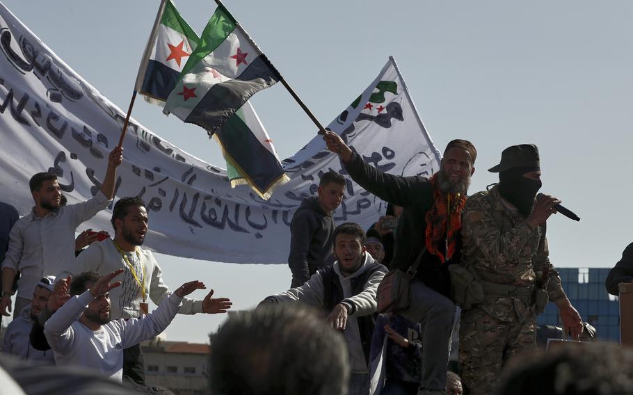 Syrians wave their new national flags