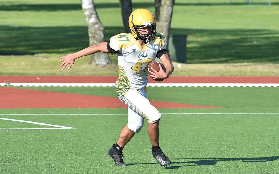 SHAPE sophomore Michael McGlothlin runs with the football during an Aug. 27, 2024, practice in Mons, Belgium.