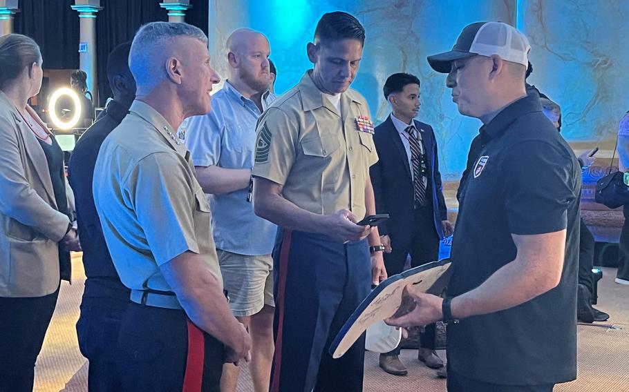 Marine Corps Commandant Gen. Eric M. Smith, left, gets a tutorial on Call of Duty at Call of Duty Endowment Bowl V in Washington on Aug. 28, 2024.