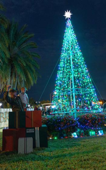 The Christmas tree, freshly lit, glows blue and green at Camp Foster.