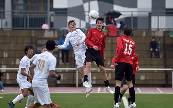 Kaiserslautern's Wesley Manson beats Ramstein's Kai Woodstock and heads the ball during a March 13, 2025, match at Kaiserslautern High School in Kaiserslautern, Germany.