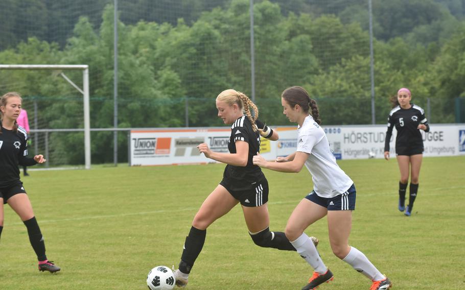 Black Forest Academy's Sierra Tweedy chases Vicenza's Avonlea Sparling and the ball Wednesday, May 22, 2024, at the DODEA European Division II boys soccer championships at Reichenbach-Steegen, Germany.