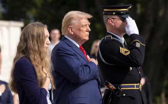 Misty Fuoco, left, sister of Nicole Gee, and Republican presidential nominee former President Donald Trump place their hands over their heart after placing a wreath in honor of Sgt. Nicole Gee, at the Tomb of the Unknown Solider at Arlington National Cemetery, Monday, Aug. 26, 2024, in Arlington, Va. (AP Photo/Alex Brandon)