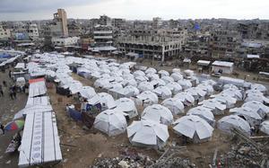 A sprawling tent camp for displaced Palestinians sits adjacent to destroyed homes and buildings in Gaza City, Gaza Strip, Saturday, March 1, 2025 during the Muslim holy month of Ramadan. (AP Photo/Abdel Kareem Hana)