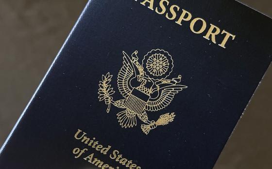 A hand holds a U.S. passport