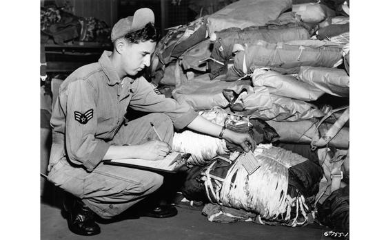 Unidentified air base,  Japan, Apr. 2, 1951:  Sgt. George K. Younce, Hickory, N.C., parachute specialist of the Far East Air Material Command (FEAMCOM) checks the chute as they come into FEAMCOM's speciallly equipped repair shops. FEAMCOM is charged with the inspection, repair and re-packing of parachutes used throughout the U.S. Far East Air Forces.

Looking for Stars and Stripes’ historic coverage? Subscribe to Stars and Stripes’ historic newspaper archive! We have digitized our 1948-1999 European and Pacific editions, as well as several of our WWII editions and made them available online through https://starsandstripes.newspaperarchive.com/

META TAGS: Pacific; Japan; U.S. Air Force; military supplies; Korean War; Far East Air Material Command; FEAMCOM; servicemember; airman