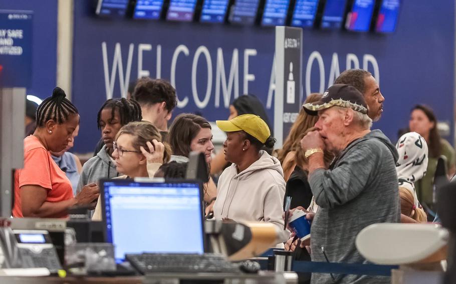 Passengers seek assistance at Delta ticket counters at Hartsfield-Jackson International Airport on Wednesday, July 24, 2024. 