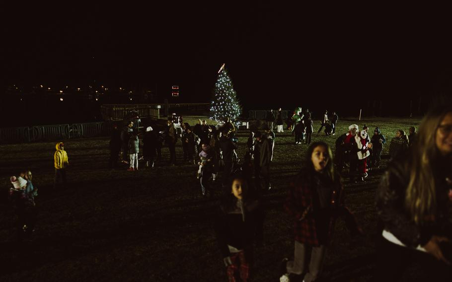 The just-lit Christmas tree at Marine Corps Air Station New River shines in the distance.