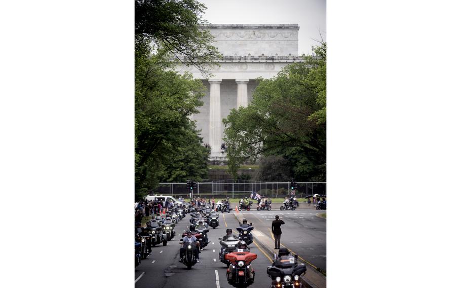 Army National Guard Specialist Joseph Wolfe salutes hundreds of people riding as part of Rolling to Remember.