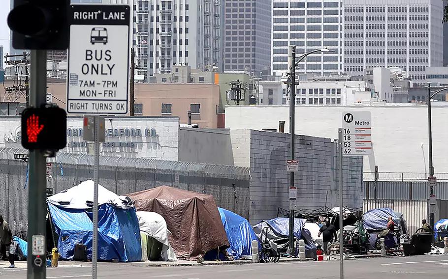 Tents that serve as shelter for homeless people line the sidewalk along Fifth Street in downtown Los Angeles.