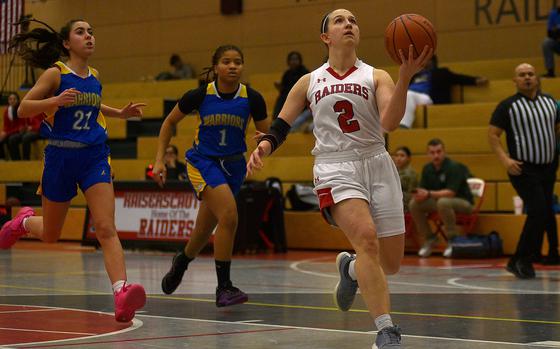 Kaiserslautern's Elizabeth Marriott goes up for a layup on the fast break ahead of Wiesbaden's Katie Shea, left, and Kaitlynn Boman during a Jan. 14, 2025, game at Kaiserslautern High School in Kaiserslautern, Germany.