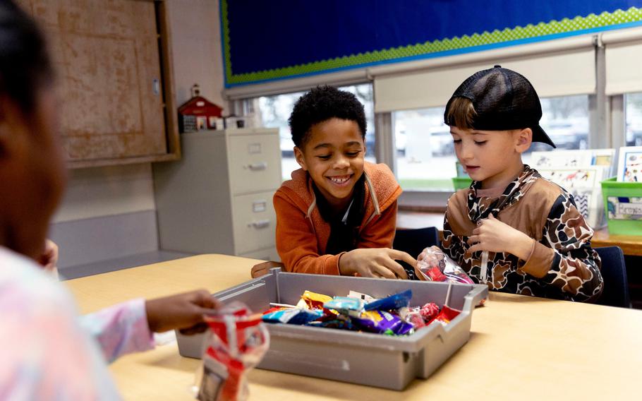 First and second grade students help fill bags of donated Halloween candy