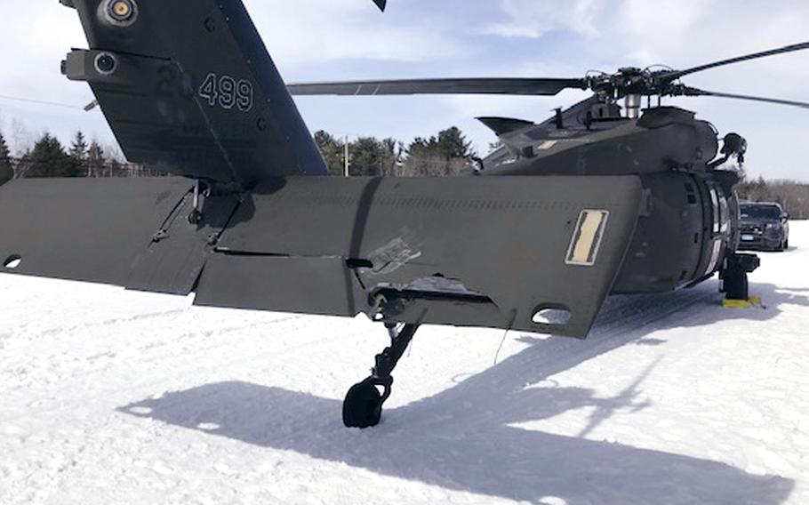 A photo of the damaged Black Hawk helicopter on a snowmobile trail