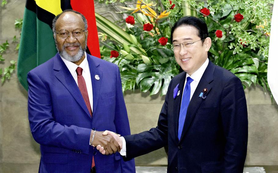 Vanuatu Prime Minister Charlot Salwai and Japanese Prime Minister Fumio Kishida shake hands with at the prime minister’s Office in Tokyo on Tuesday. 