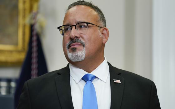 FILE - Education Secretary Miguel Cardona listens as President Joe ...