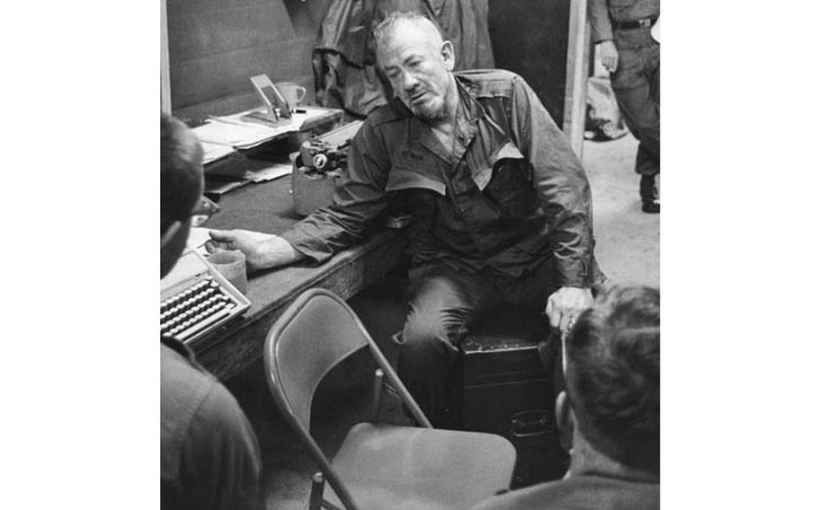 Novelist John Steinbeck talks to soldiers at An Khe, South Vietnam, in December, 1966.