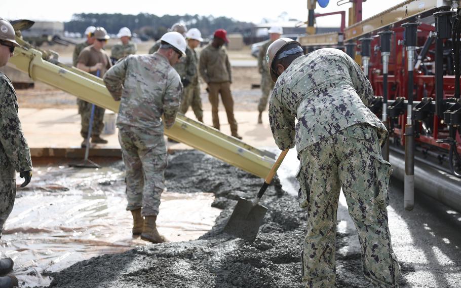 Seabees pour concrete for a runway.