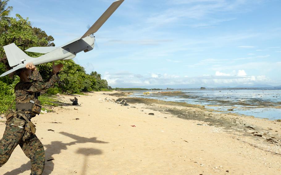 Sgt. Vincent Tran, a maritime sensing chief with Marine Rotational Force -- Southeast Asia, launches an RQ-20 Puma drone during training in Sorsogon, Philippines, Oct. 9, 2023. 