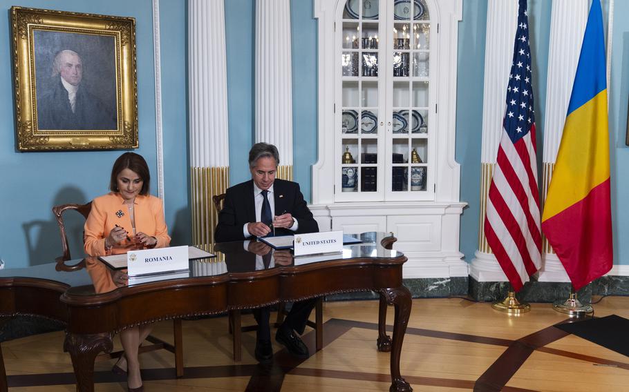 Secretary of State Antony Blinken and Romanian Foreign Minister Luminița-Teodora Odobescu, left, sign a memorandum of understanding during a ceremony at the State Department, Friday, June 21, 2024, in Washington. 