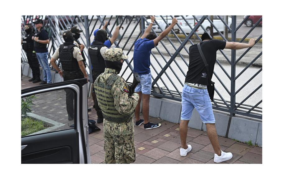 Men suspected of belonging to a criminal gang remain detained in Guayaquil, Ecuador, on Jan. 15, 2024, during a joint operation between the Ecuadorean National Police and members of the armed forces to prevent violent acts.