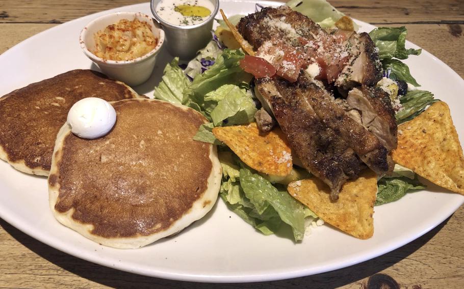 A plate of pancakes, grilled chicken, salad and Doritos make a colorful combination at Kona’s Coffee.