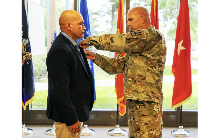Maj. Gen. Ray Shields, the adjutant general of New York, presents the Bronze Star Medal with “V” device to retired Master Sgt. Luis Barsallo during a ceremony at New York Division of Military and Naval Affairs headquarters in Latham, N.Y., on June 27, 2024. 