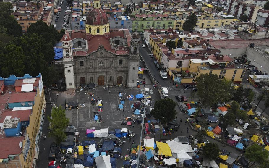 An aerial view of a migrant tent encampment set up on the plaza of the Santa Cruz y La Soledad Catholic parish church, in La Merced neighborhood of Mexico City, Dec. 26, 2023. 