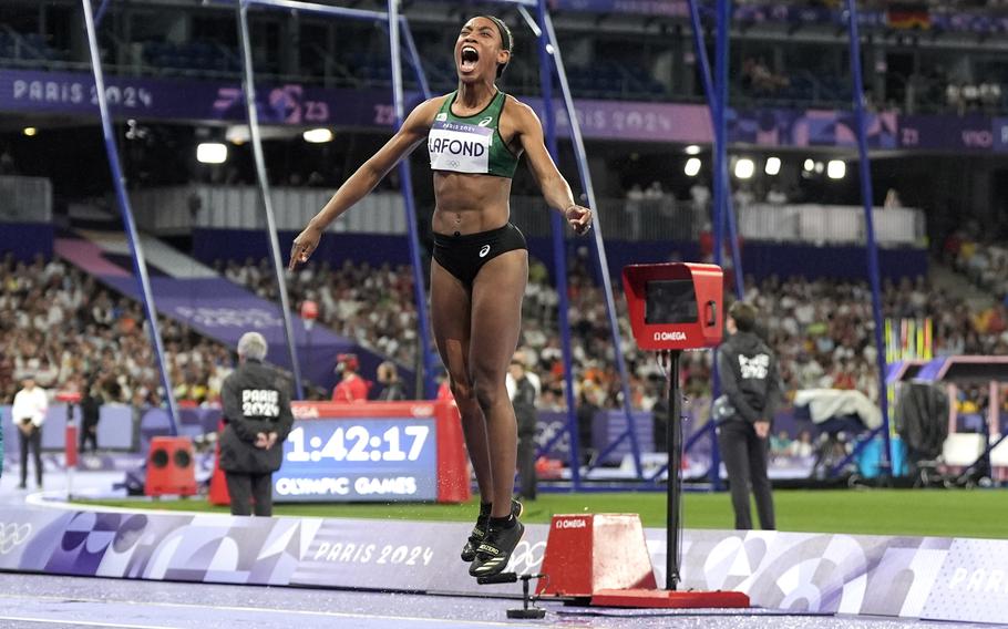 Thea Lafond, of Dominica, celebrates after winning the women's triple jump final at the 2024 Summer Olympics, Saturday, Aug. 3, 2024, in Saint-Denis, France. (AP Photo/Matthias Schrader)