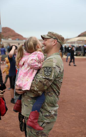 More than 150 service members of the 856th Military Police Company from the Arizona Army National Guard rally together with their families on Bushmaster Field in Phoenix, Ariz., for an send-off ceremony Sunday, Jan. 21, 2024. 