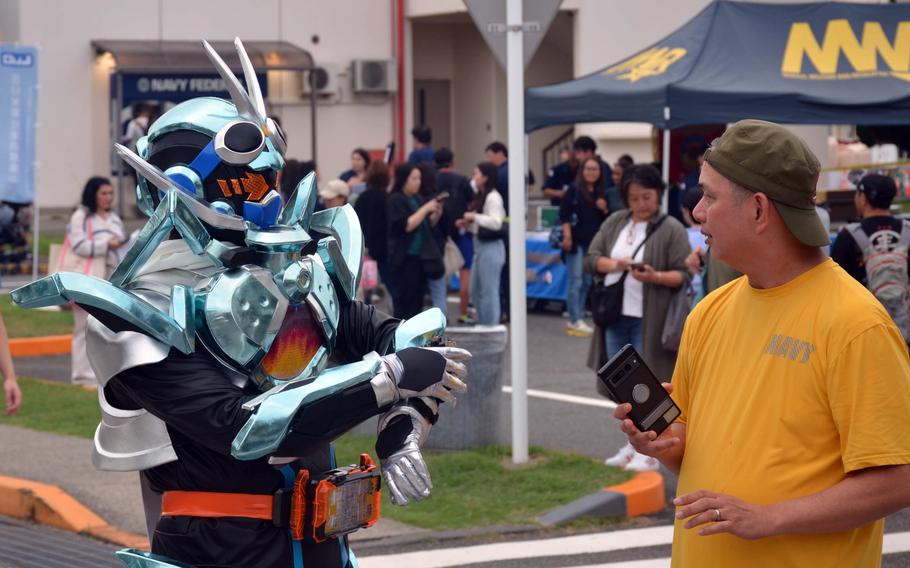 A cosplayer chats with a festivalgoer during Friendship Day at Yokosuka Naval Base.