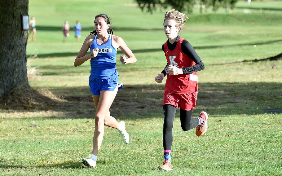 Brussels' Haley Mitchell and Kaiserslautern's Owen Porter run side by side during a race on Oct. 14, 2023, at Rolling Hills Golf Course in Baumholder, Germany.