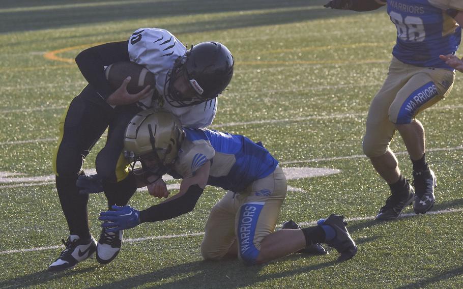 Wiesbaden senior Munro Davis tackles Stuttgart quarterback Kai Lewis during a game in Wiesbaden, Germany on Sept. 13, 2024.