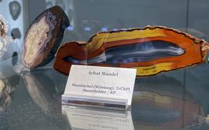 This agate rock in the shape of an almond shows its brightly colored, striped deposits. The formation, found in the abandoned settlement of Mambaechel, north of Baumholder, Germany, is one of many local gemstones and rock formations on display at the German Minerals Museum in Idar-Oberstein.