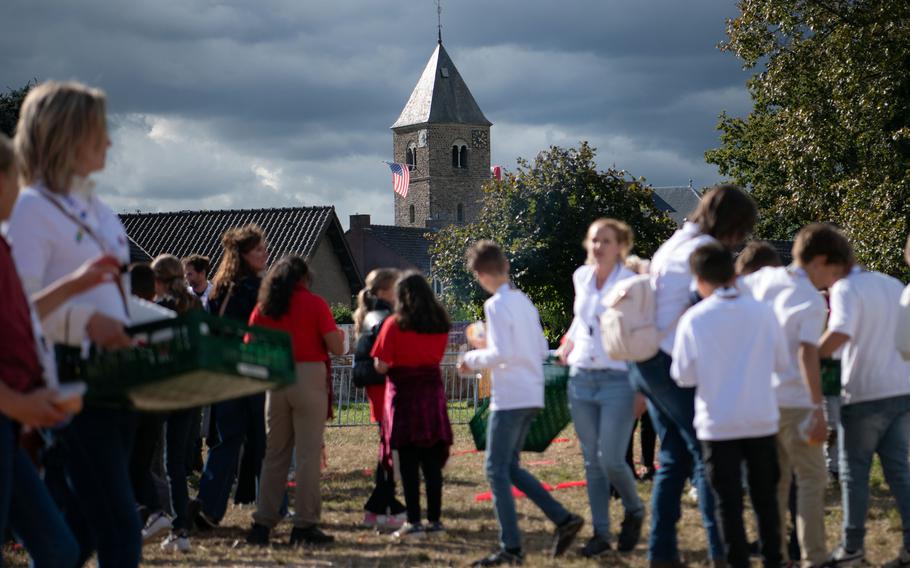 School children attend commemorations in Mesch, Netherlands, on Thursday, Sept. 12, 2024, to mark 80 years since U.S. forces liberated the village during World War II. A large American flat hangs from the village church in the background.